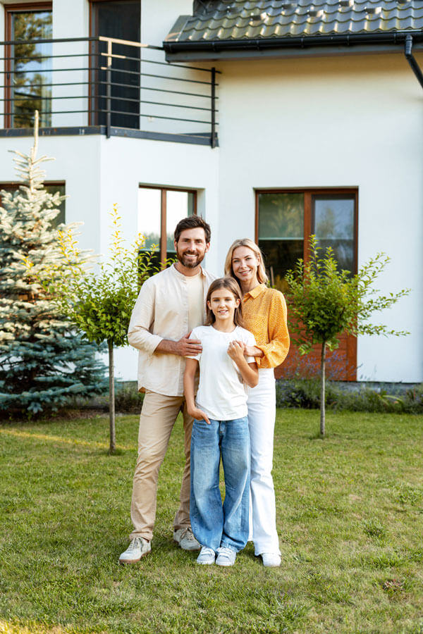A happy family standing in their home garden, representing reliable AAA home insurance in Westland, MI.