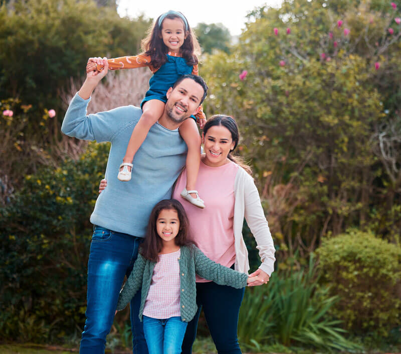A loving happy family in Garden City, MI, symbolizing asset protection and reliable AAA life insurance policies at Mark Ismail Insurance Agency.